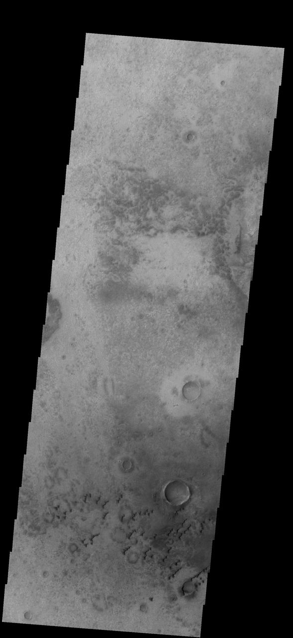 This image from NASA 2001 Mars Odyssey spacecraft shows small sets of dunes on the plains of Aonia Terra.