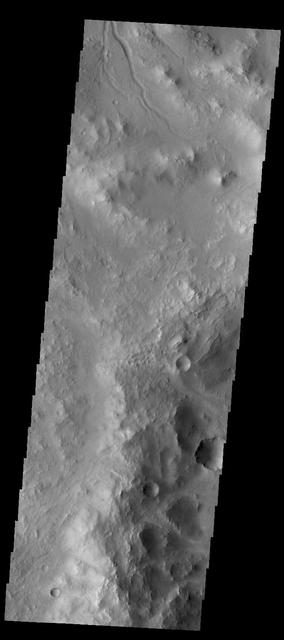 The small channel at the top of this image from NASA 2001 Mars Odyssey spacecraft is located on the rim of an unnamed crater in Terra Sabaea.