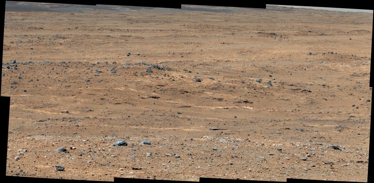 An outcrop visible as light-toned streaks in the lower center of this image has been chosen as a place for NASA Mars rover Curiosity to study for a few days in September 2013.