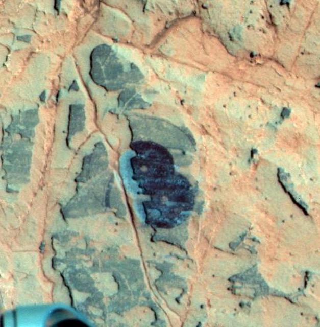 NASA image: Mineral Detected from Orbit Found in Dark Veneers