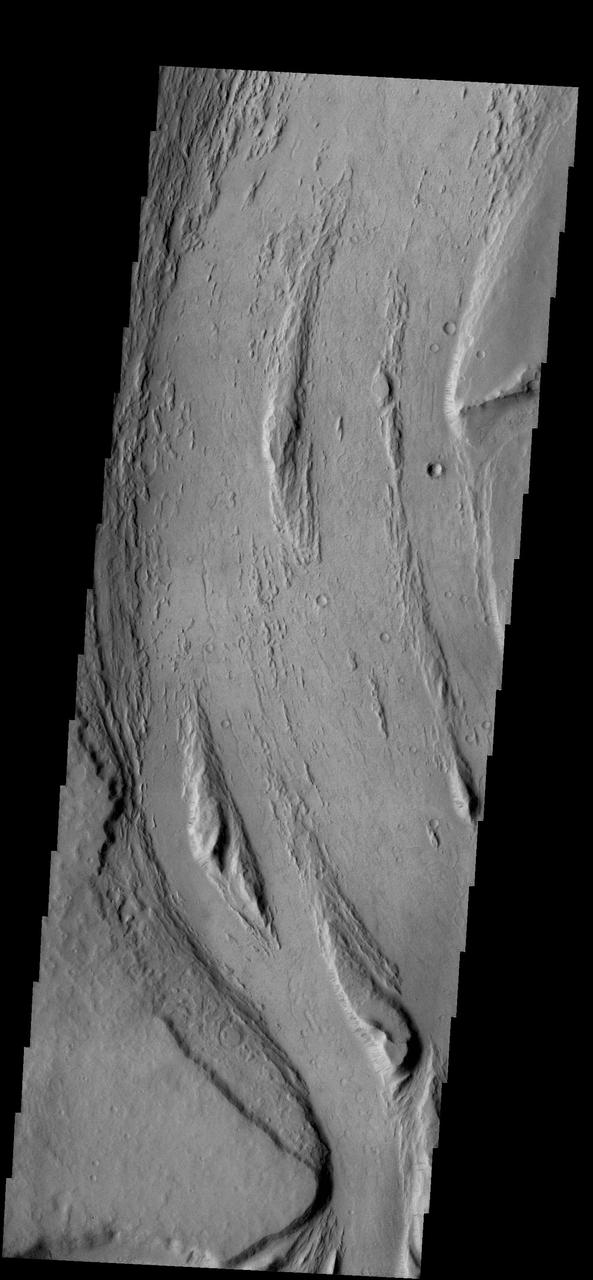 This VIS image captured by NASA 2001 Mars Odyssey spacecraft shows streamlined islands are located in the channel of Mangala Valles, a portion of which is shown in the image.