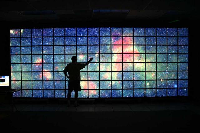 The center of the Milky Way galaxy imaged by NASA Spitzer Space Telescope is displayed on a quarter-of-a-billion-pixel, high-definition 23-foot-wide 7-meter LCD science visualization screen at NASA Ames Research Center.