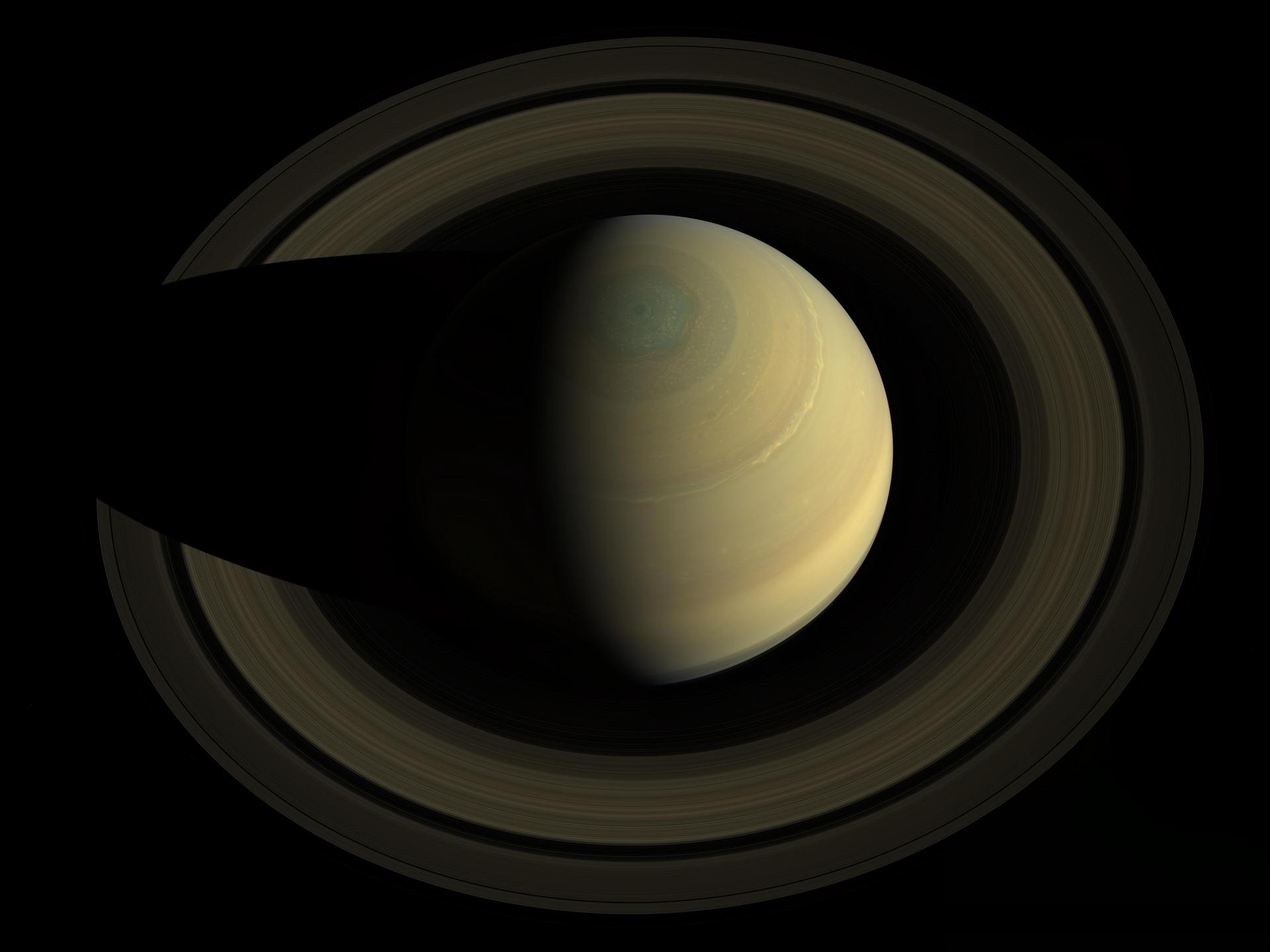 A swing high above Saturn by NASA Cassini spacecraft revealed this stately view of the golden-hued planet and its main rings. Saturn sports differently colored bands of weather in this image.
