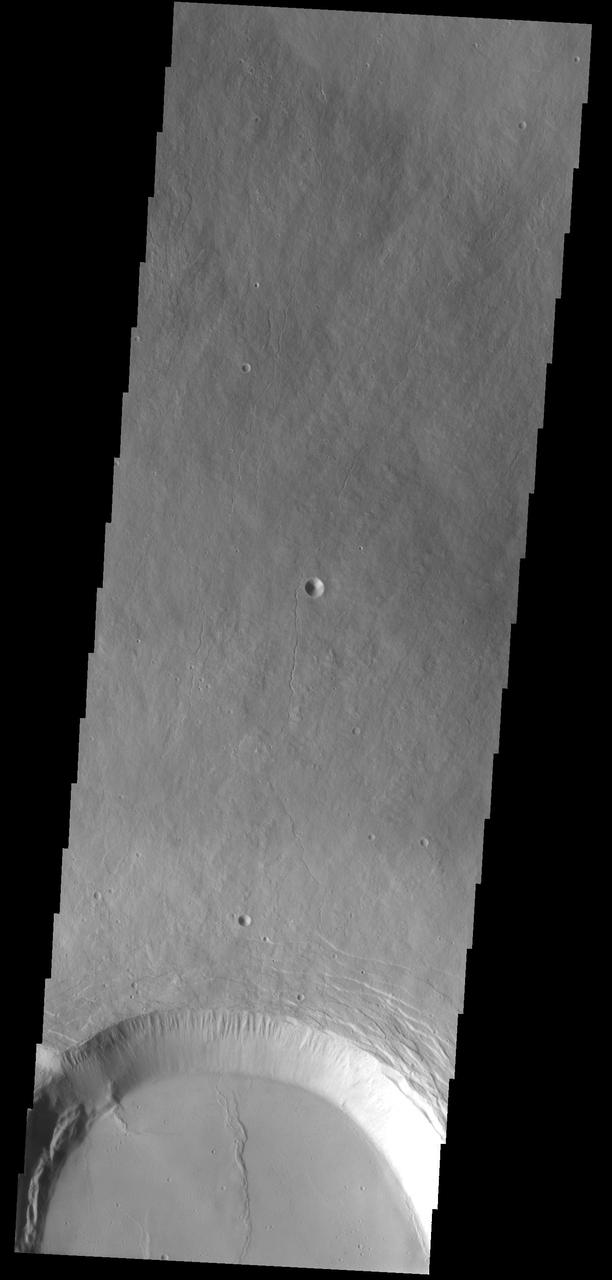 Part of the summit caldera of Olympus Mons is visible at the bottom of this image as seen by NASA 2001 Mars Odyssey spacecraft.
