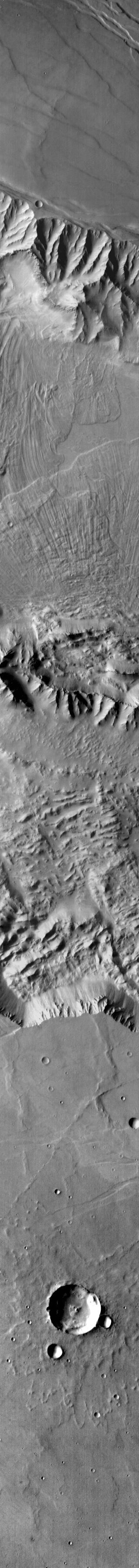 The landslide deposits in this infrared image from NASA 2001 Mars Odyssey spacecraft are located in Valles Marineris and are called Coprates Labes.