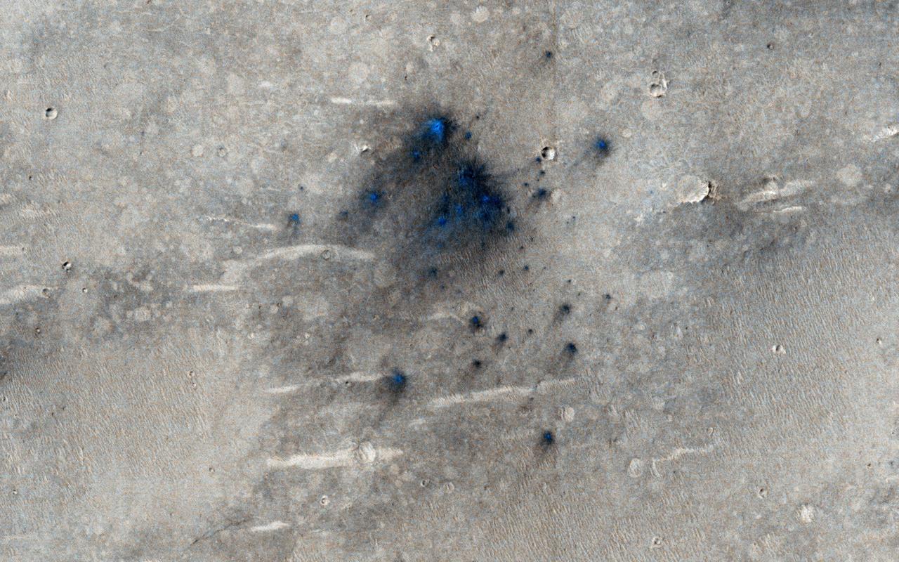 This cluster of small impact craters was spotted by the Context Camera on Mars Reconnaissance Orbiter in the region northwest of Gale Crater, the landing site of the Mars Science Laboratory MSL rover, Curiosity.