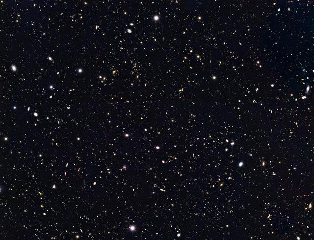 The view is a composite of images taken in visible and near-infrared light by NASA Hubble Space Telescope. Researchers have circled four unusually red objects that appear as they existed just 500 million years after the big bang.