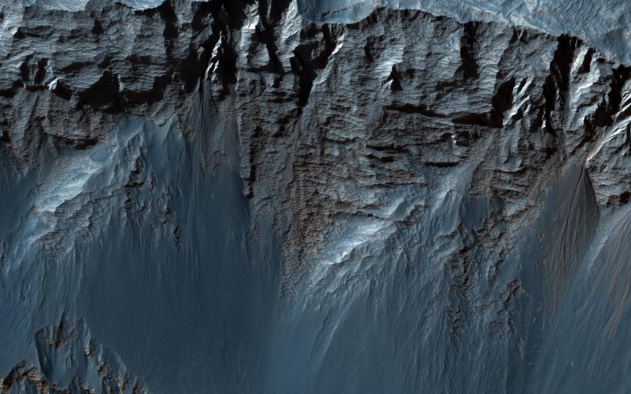 This beautiful image shows terrific layers and exposed bedrock along a cliff in west Candor Chasma, which is part of the extensive Valles Marineris canyon system as seen by NASA Mars Reconnaissance Orbiter.