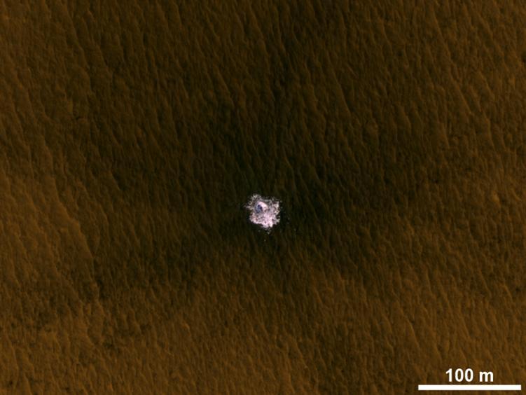 The image is an excerpt from an observation from NASA Mars Reconnaissance Orbiter showing a meteorite impact that excavated this crater on Mars exposed bright ice that had been hidden just beneath the surface at this location.