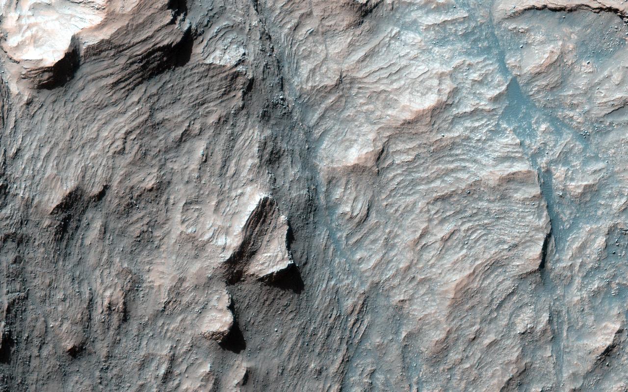 This is only one of four impact craters on Mars known that possesses intact layers exposed in the central uplift in this image from NASA Mars Reconnaissance Orbiter.