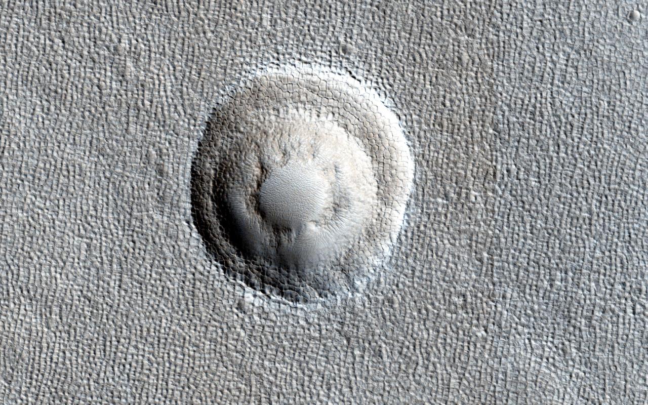 Small impact craters usually have simple bowl shapes; however, when the target material has different layers of different strength, then more complicated crater shapes can emerge as shown in image captured by NASA Mars Reconnaissance Orbiter.