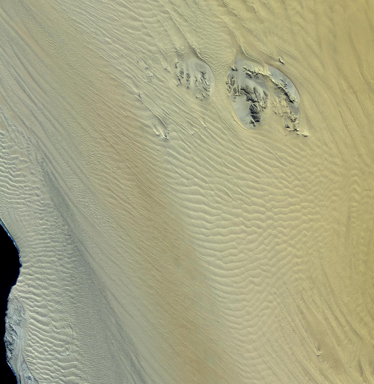 This image, acquired by NASA Terra spacecraft, shows the Namib Desert, a coastal desert in southern Africa. This portion in central Namibia consists entirely of linear and longitudinal sand dunes.