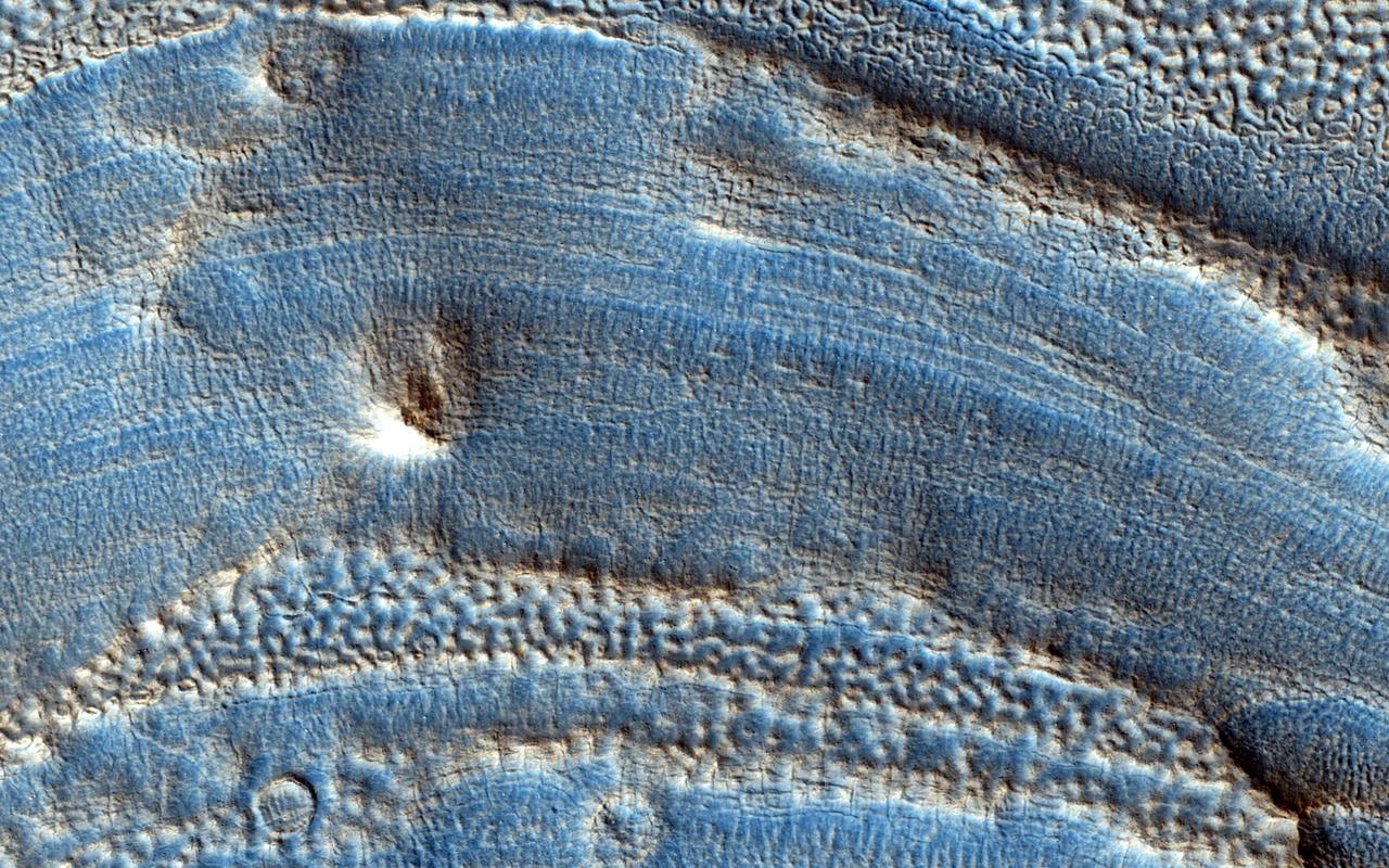 This image captured by NASA Mars Reconnaissance Orbiter spans from wall to wall across the center area of an impact crater. From what we see, a lot has happened to modify the appearance of the crater since it was formed.