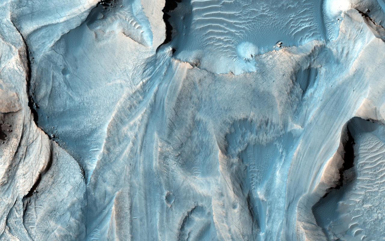 This observation from NASA Mars Reconnaissance Orbiter covers an outcrop of possible cyclic bedding within a crater in Arabia Terra.
