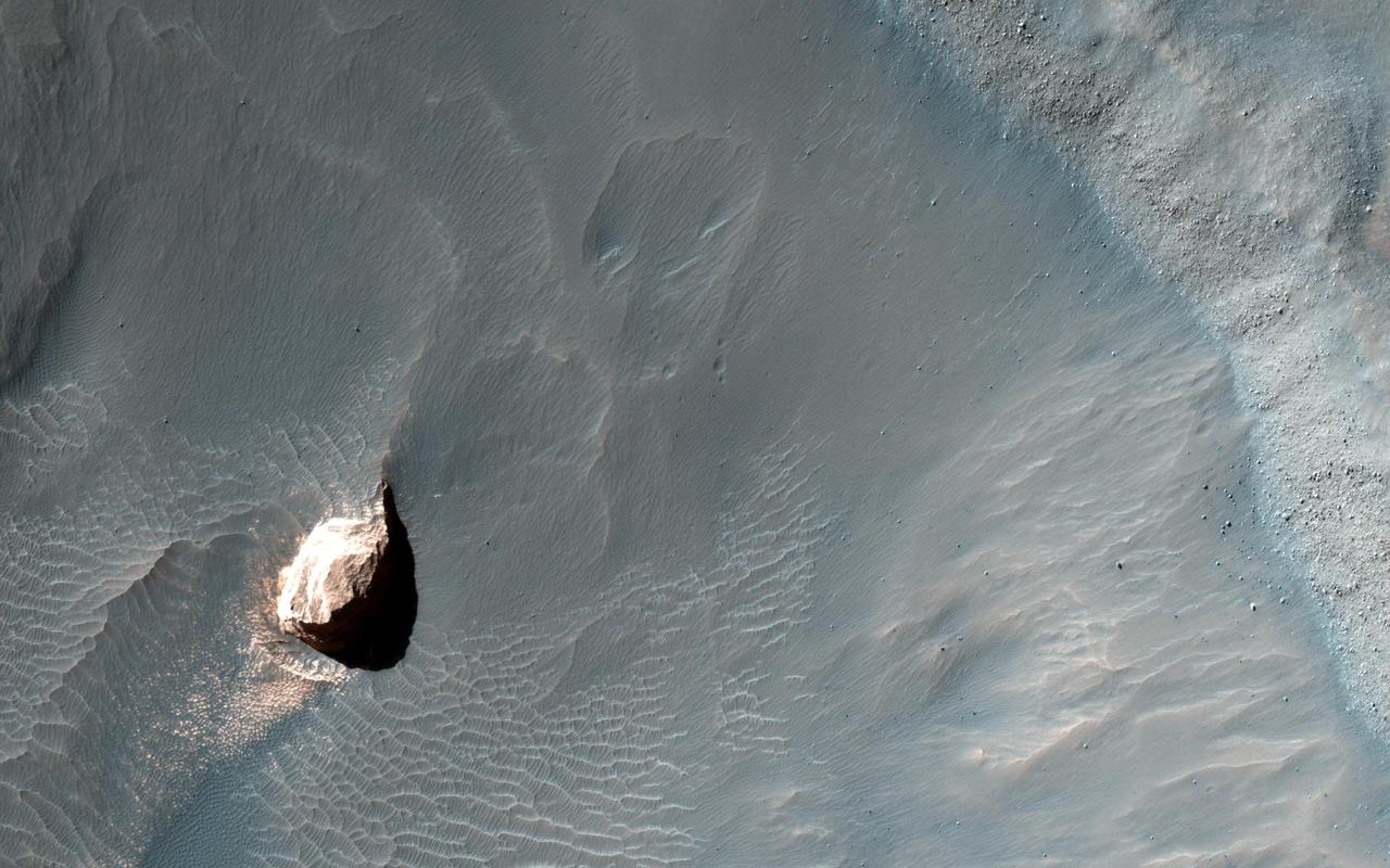 This observation captured by NASA Mars Reconnaissance Orbiter shows a small crater in within the much larger Pollack Crater containing light-toned material.