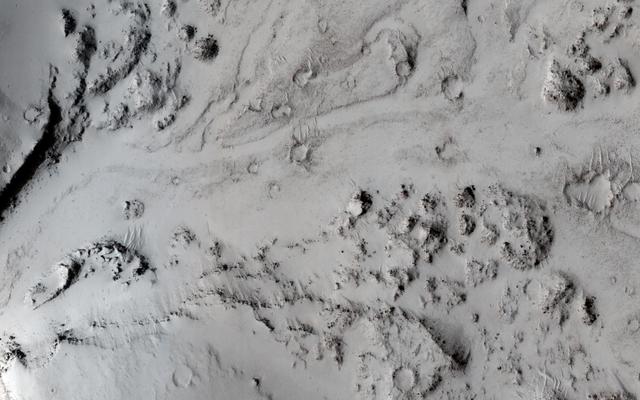 NASA image: Breaching a Crater Rim in Tartarus Montes