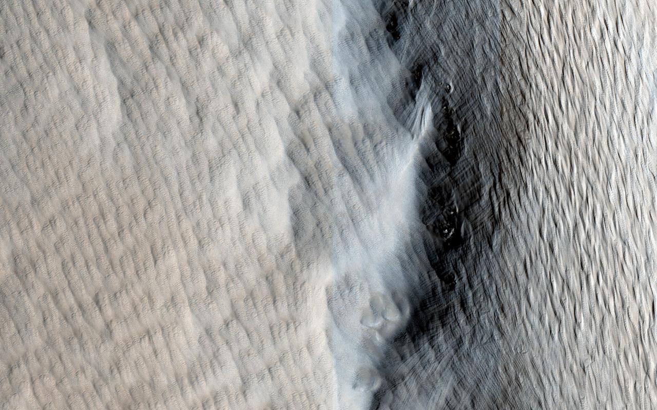 This image captured by NASA Mars Reconnaissance Orbiter shows Tharsis Tholus, one of the smaller shield volcanoes on Mars massive Tharsis Rise.