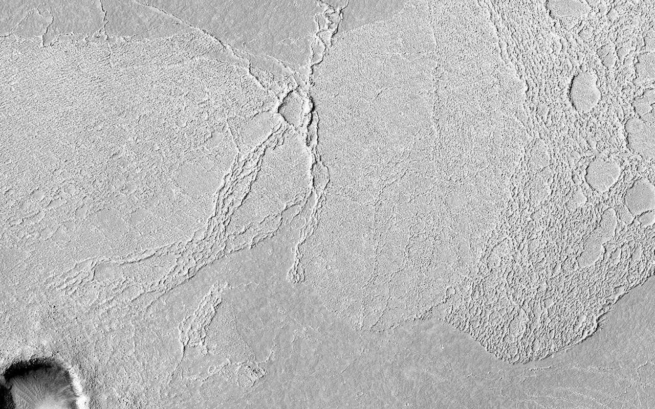 This image covers part of the Athabasca Valles flood lava plain, the youngest large lava flow on the surface of Mars as observed by NASA Mars Reconnaissance Orbiter.