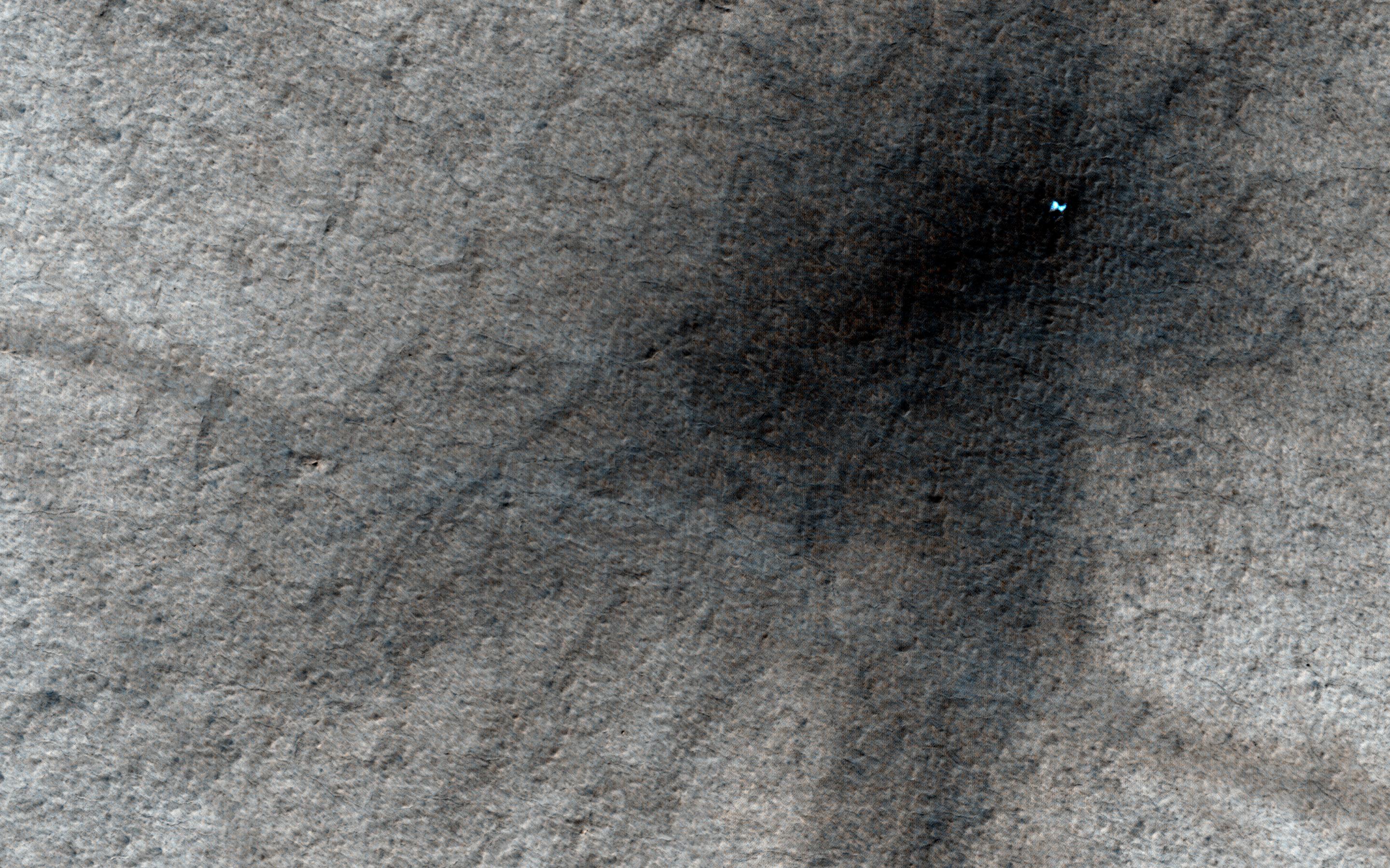 These craters on Tharsis are first visible as new dark spots observed by NASA Mars Reconnaissance Orbiter Context Camera CTX, which can view much larger areas, and then imaged by HiRISE for a close-up look.
