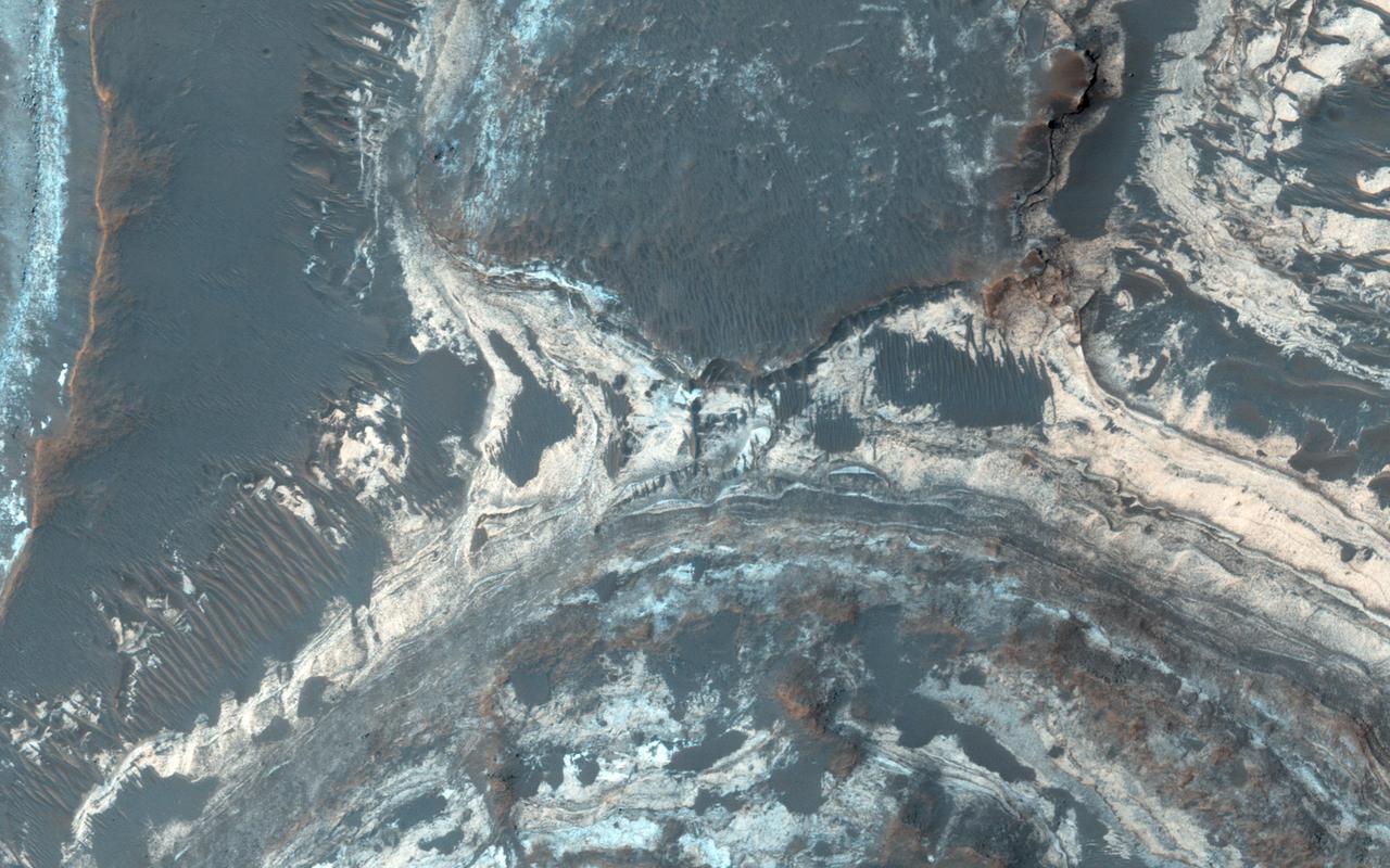 Excellent exposures of light-toned layered deposits occur along the northern edge of Hellas Basin as seen by NASA Mars Reconnaissance Orbiter.