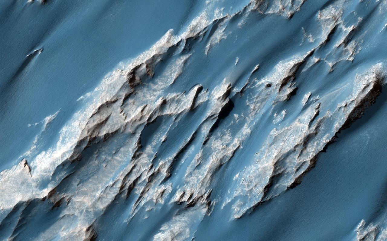 This image captured by NASA Mars Reconnaissance Orbiter is of an ancient, approximately 3 billion year-old landslide shows two distinct surface albedos, which are proportions of reflected light.