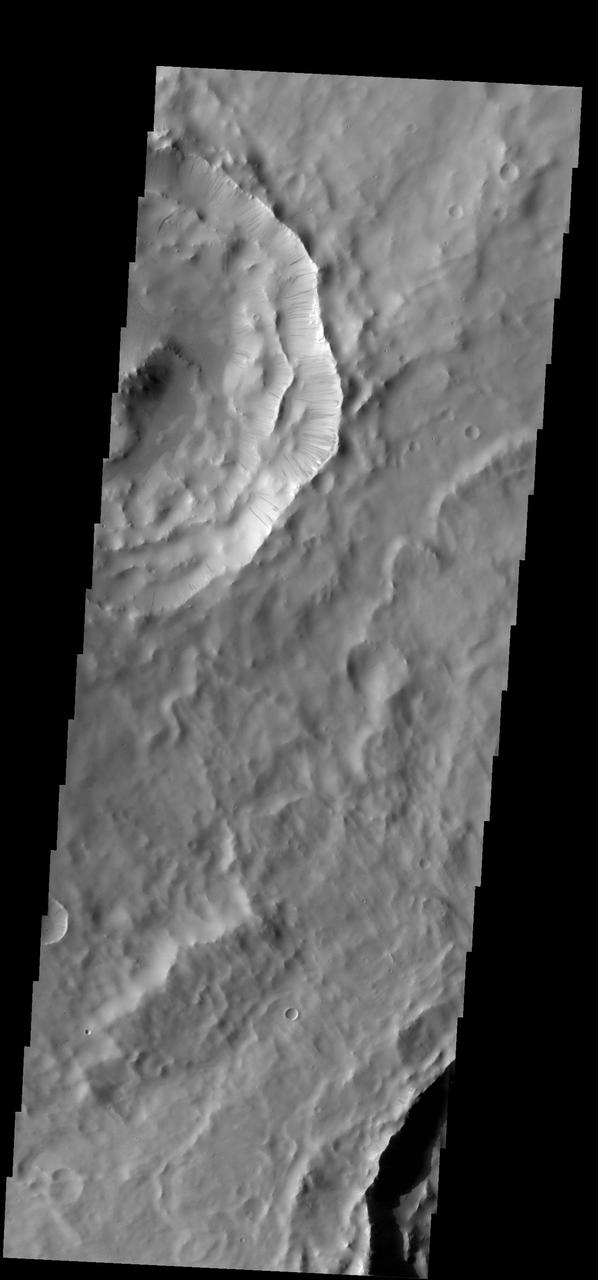 Numerous dark slope streaks are located on the inner rim of this unnamed crater in Terra Sabaea. This image is from NASA 2001 Mars Odyssey spacecraft.