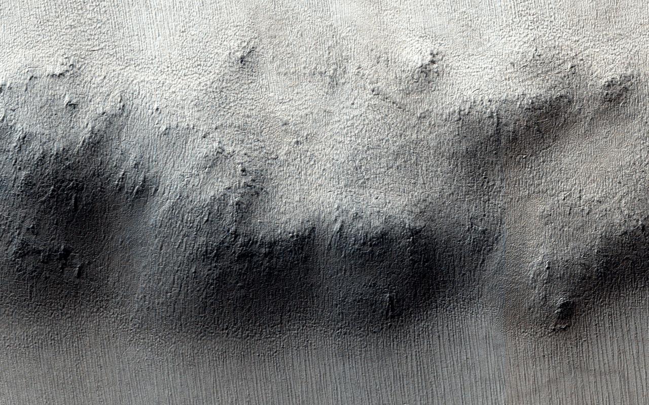 These craters on Tharsis are first visible as new dark spots observed by NASA Mars Reconnaissance Orbiter Context Camera CTX, which can view much larger areas, and then imaged by HiRISE for a close-up look.