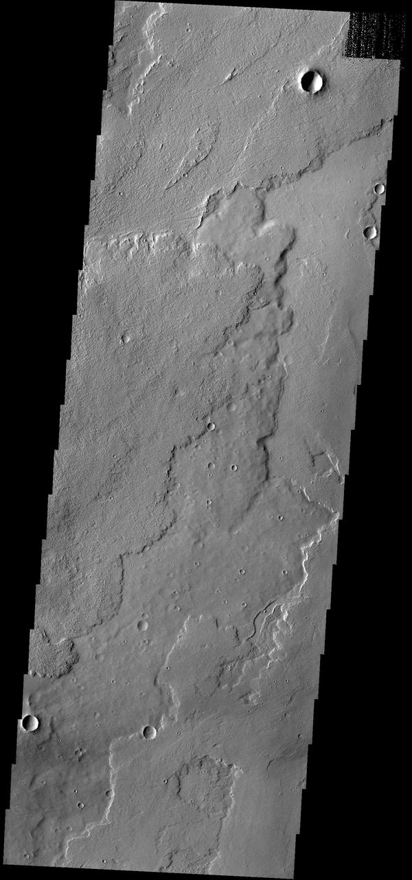 The lava flows in this image captured by NASA 2001 Mars Odyssey spacecraft are located of the eastern margin of the Tharsis Volcanic complex.