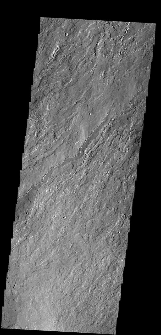The narrow flows and channels in this image captured by NASA 2001 Mars Odyssey spacecraft are located on the northeastern margin of Olympus Mons.