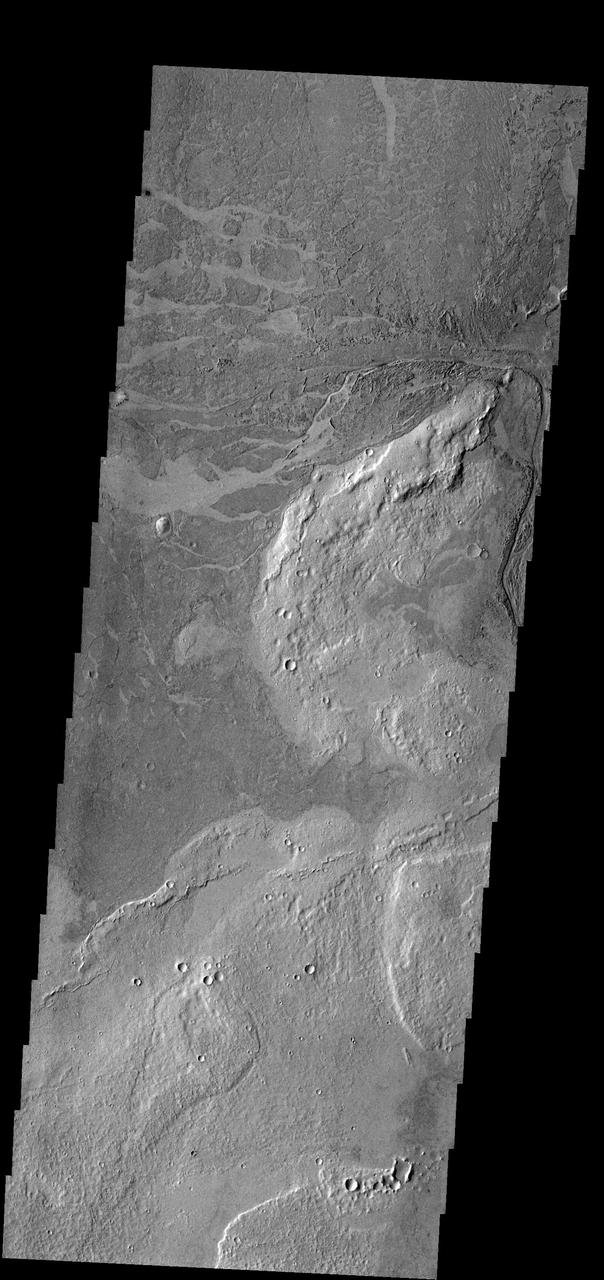This image near Athabasca Valles shows thin plate of lava as seen by NASA 2001 Mars Odyssey spacecraft. This style of lava flow is very different from other lava flows in the nearby Elysium and Tharsis volcanic complexes.