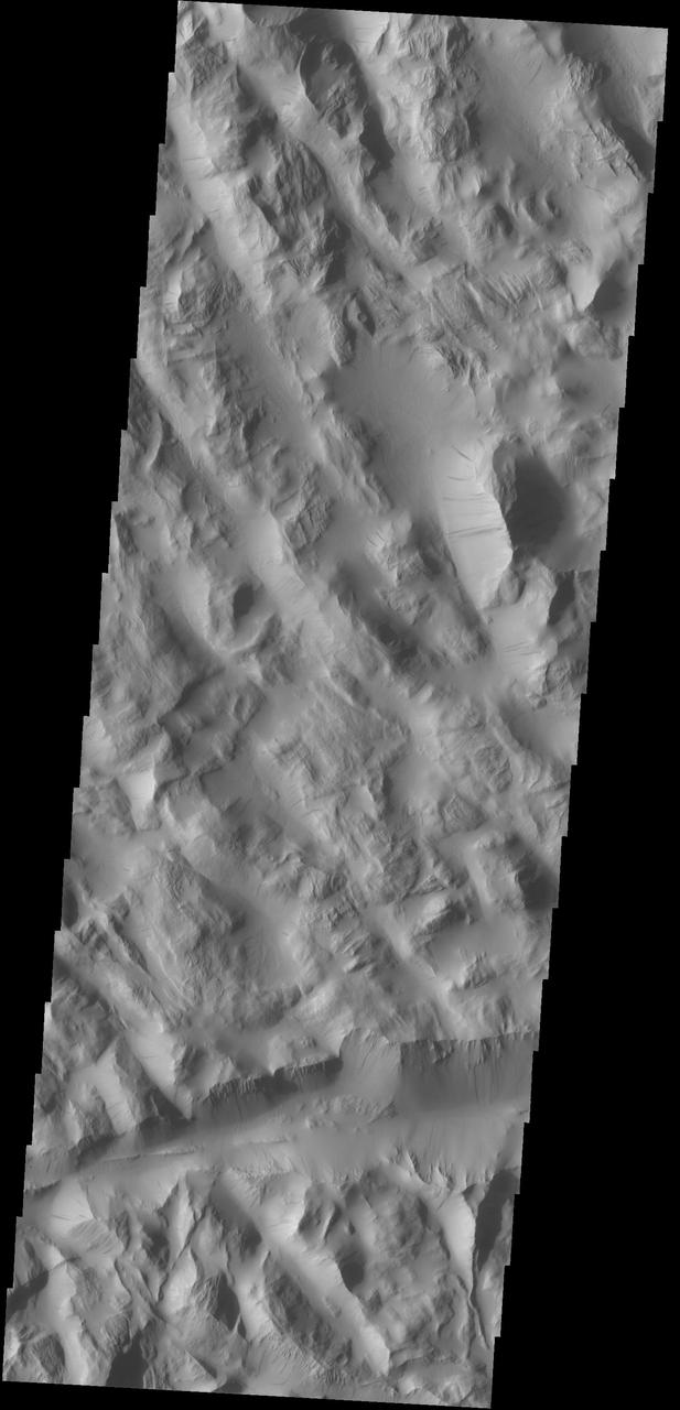 Dark slope streaks mark the hill sides in Lycus Sulci as seen by NASA 2001 Mars Odyssey spacecraft.