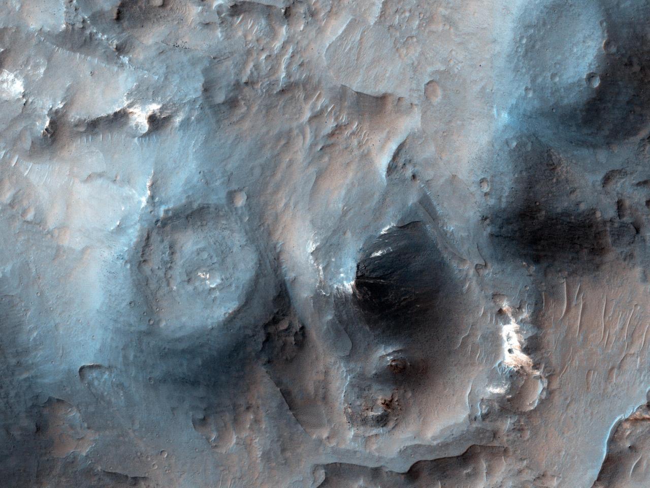 This image from NASA Mars Reconnaissance Orbiter shows cones with summit pits that are very similar to cinder cones on Earth. They are also very well-preserved, peppered by only small impact craters, so they must be geologically young.