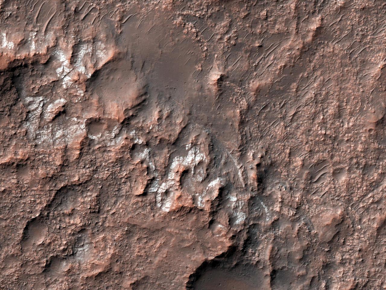 This image from NASA Mars Reconnaissance Orbiter shows chlorides that have a bright appearance and are covered by other dark materials.
