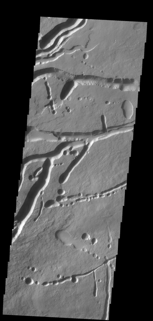 The pits, fractures and channel-like features captured by NASA 2001 Mars Odyssey spacecraft are located on the northern flank of Ascraeus Mons. Most of these features were created by collapse into lava tubes that existed below the surface.