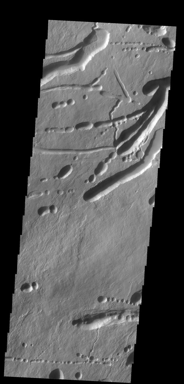 This image shows a different portion of the collapse features located on the northern flank of Ascraeus Mons as seen by NASA 2001 Mars Odyssey spacecraft.