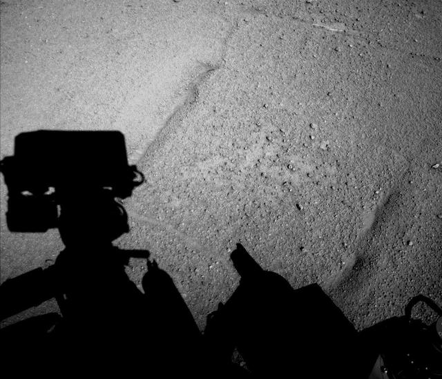 NASA Curiosity Mars rover caught its own shadow in this image taken just after completing a drive of 329 feet 100.3 meters on the 547th Martian day, or sol, of the rover work on Mars Feb. 18, 2014.
