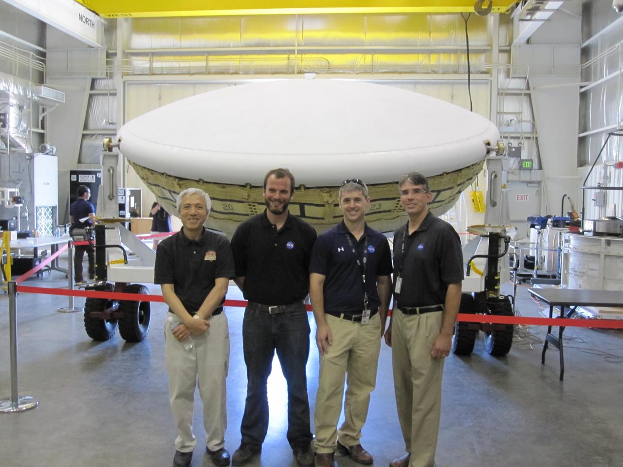 Members of the team for NASA Low-Density Supersonic Decelerator LDSD stand in front of the project saucer-shaped test vehicle at the U.S. Navy Pacific Missile Range Facility in Kauai, Hawaii.