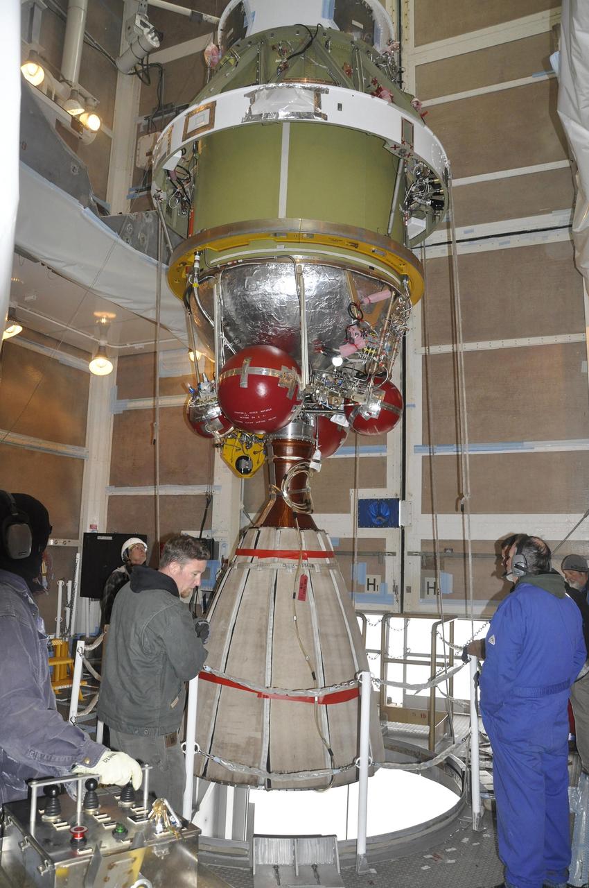 Workers monitor the Delta II second stage for NASA OCO-2, as it is lifted into position for mating with the rocket first stage in the mobile service tower at Space Launch Complex 2 on Vandenberg Air Force Base in California.
