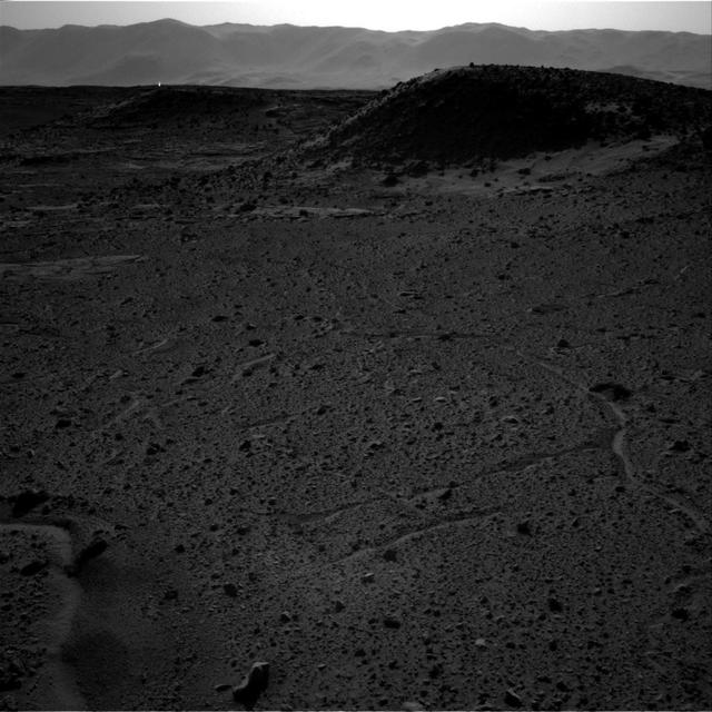This image from NASA Curiosity Mars rover, taken on April 3, 2014, includes a bright spot near the upper left corner. Possible explanations include a glint from a rock or a cosmic-ray hit.