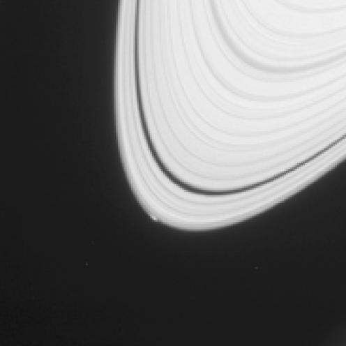 The disturbance visible at the outer edge of Saturn A ring in this image from NASA Cassini spacecraft could be caused by an object replaying the birth process of icy moons.