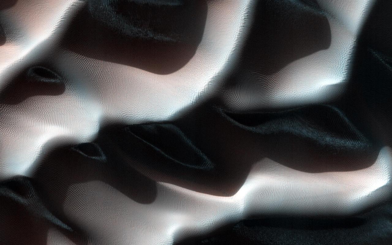 This Southern autumn image captured by NASA Mars Reconnaissance Orbiter offers a view of frosty dunes. The sunlight is shining on the dunes from the upper right.