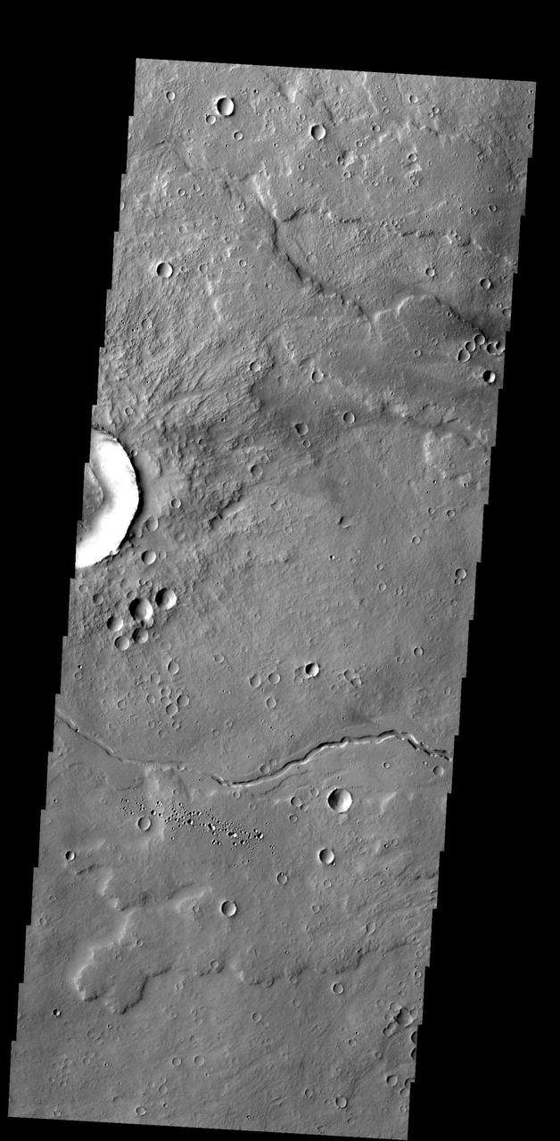 The small channel and lava flows in this image NASA 2001 Mars Odyssey spacecraft are located northeast of Olympus Mons.