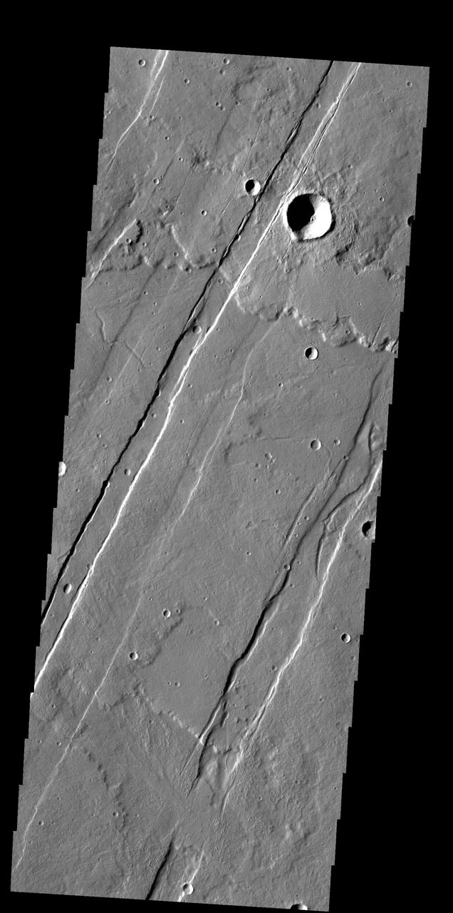 This image captured by NASA 2001 Mars Odyssey spacecraft shows several of the graben fault bounded depression that are part of Acheron Catena.