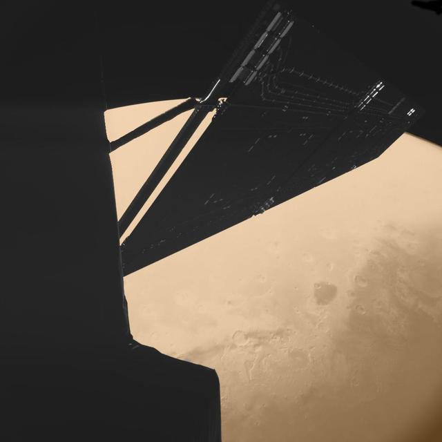 Stunning image taken by the CIVA imaging instrument on Rosetta Philae lander just 4 minutes before closest approach at a distance of some 1000 km from Mars on Feb. 25, 2007.  A portion of the spacecraft and one of its solar arrays are visible in nice detail. Beneath, the Mawrth Vallis region is visible on the planet's disk. Mawrth Vallis is particularly relevant as it is one of the areas on the Martian surface where the OMEGA instrument on board ESA's Mars Express detected the presence of hydrated clay minerals -- a sign that water may have flown abundantly on that region in the very early history of Mars.  Id 217487  http://photojournal.jpl.nasa.gov/catalog/PIA18154