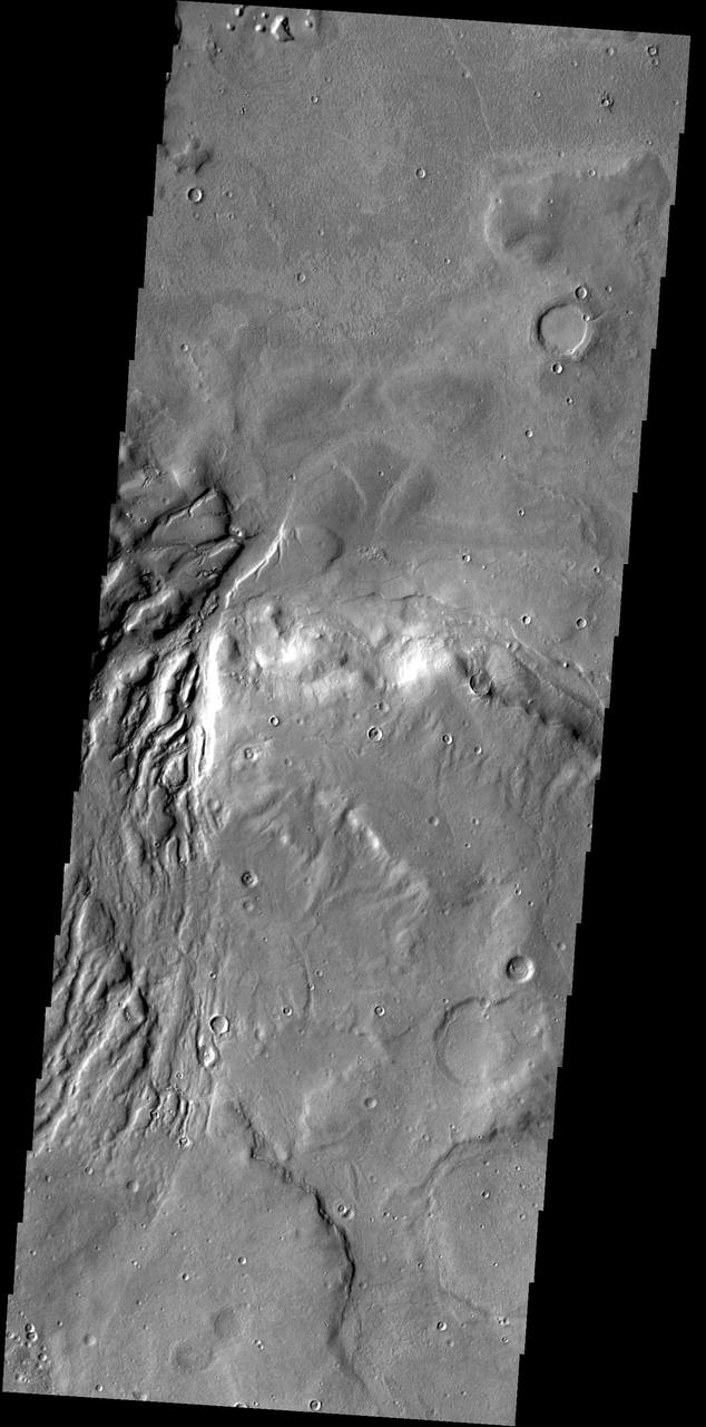 This image from NASA 2001 Mars Odyssey spacecraft shows several channels dissecting the rim of Semeykin Crater.