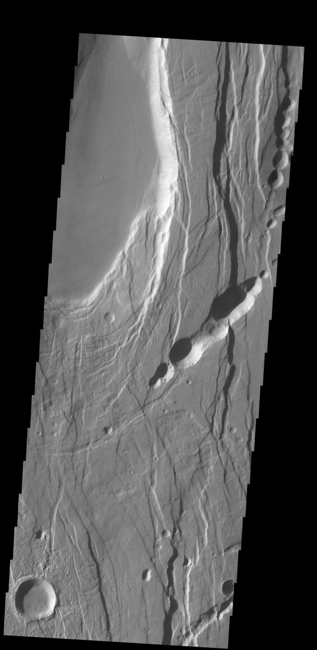 This complexly faulted region is part of Ceraunius Fossae, located south of Alba Mons. This image was captured by NASA 2001 Mars Odyssey spacecraft.