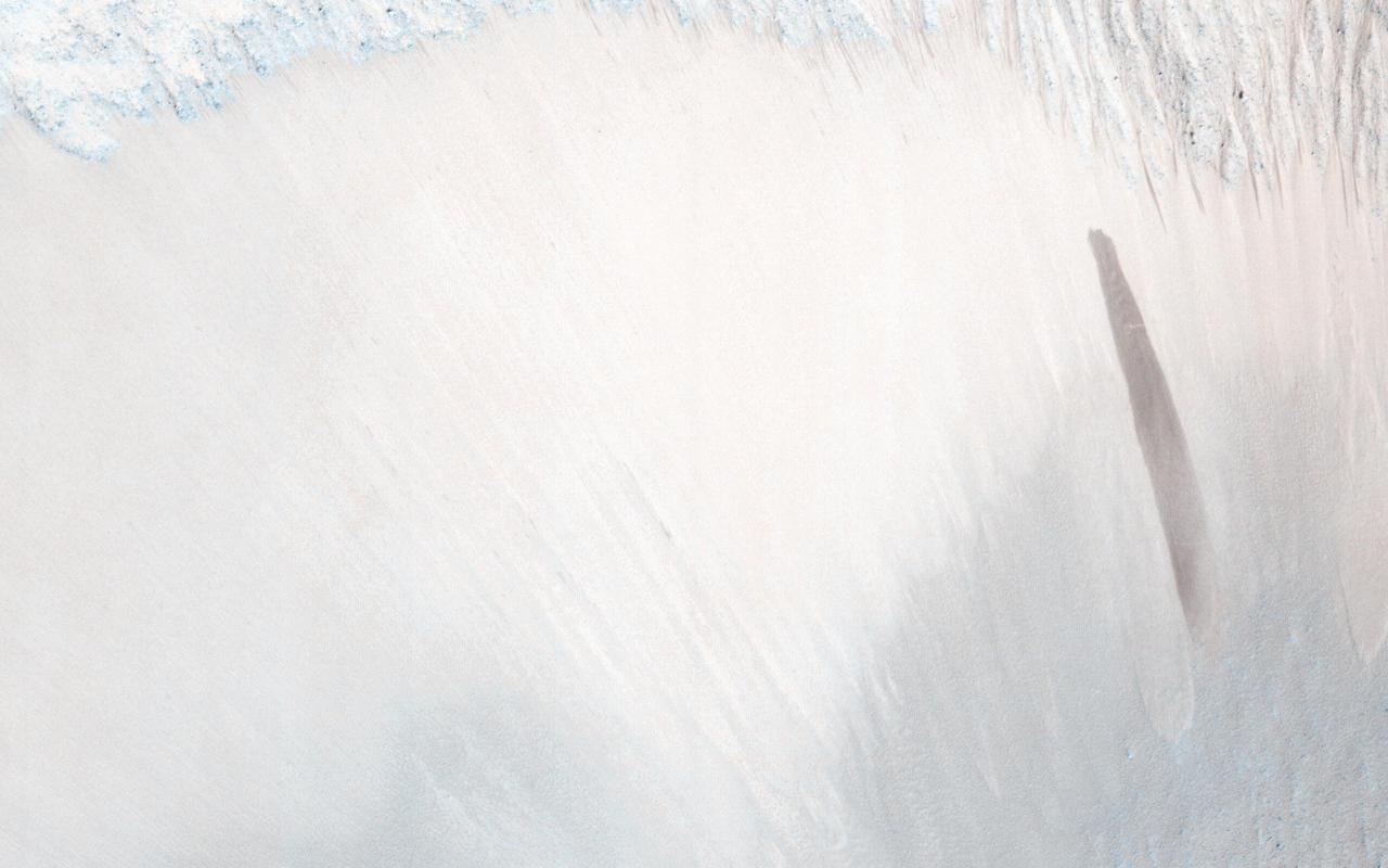 A surprise landslump in Melas Chasma was observed by NASA Mars Reconnaissance Orbiter.