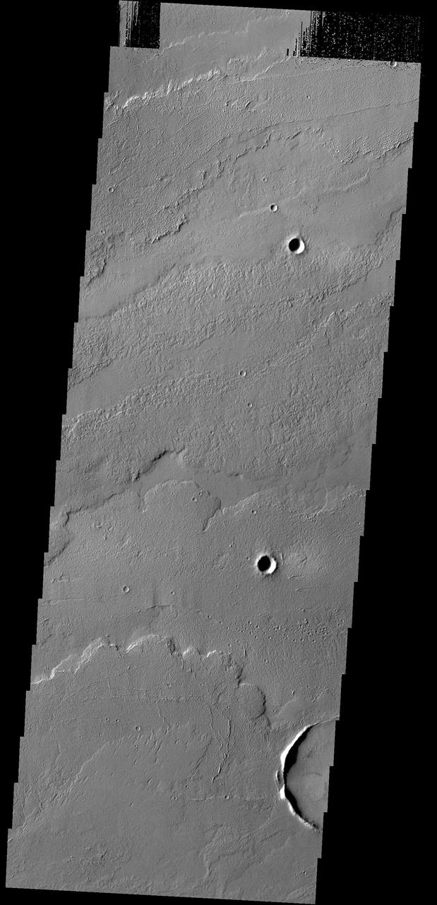 This image captured by NASA 2001 Mars Odyssey spacecraft shows some of the lava flows located east of the large Tharsis volcanoes.