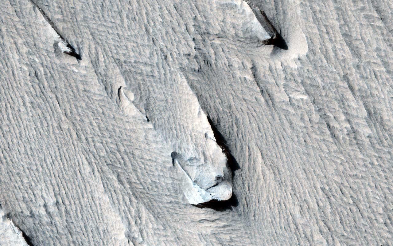 Yardangs are streamlined hills that are carved by wind erosion from bedrock. NASA Mars Reconnaissance Orbiter viewed these yardangs which can look like the hull of a boat.