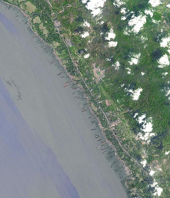 This image from NASA Terra spacecraft shows the Bangladeshi coast north of Chittagong, where ships from around the world are beached and dismantled.